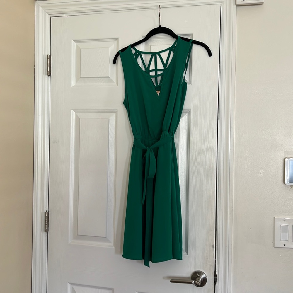 Sz. S Skies are Blue green dress with back detail and tie waist.